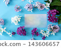Purple lilac flowers with blank card on blue background 143606657