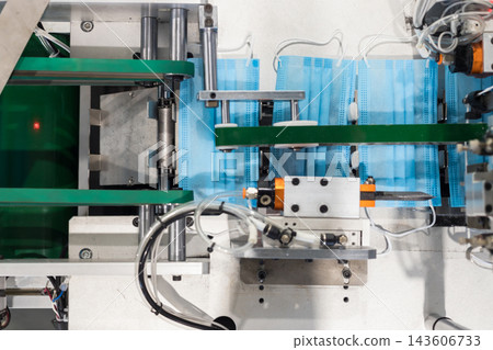 Medical mask manufacturing machine producing surgical face masks Medical mask manufacturing machine producing surgical face masks 143606733