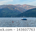 Sailing boat anchoring on lake zell with alpine hills 143607763