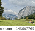 Austrian alpine house overlooking rocky trisselwand mountain 143607765