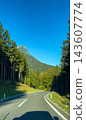 Winding road journey through austrian alpine forest 143607774