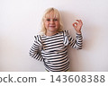 Happy Little Blonde Girl Showing OK Sign and Smiling on White Background 143608388