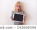 Happy Little Blonde Girl Holding Digital Tablet with Blank Screen  143608394