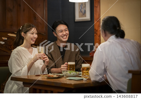 A man and woman chatting in a bar. 143608817