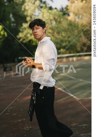 Groom Holding Glass Beside Swimming Pool Groom Holding Glass Beside Swimming Pool 143609094
