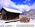 Mimasaka-Takio Station in the snow: an old railway baggage handling building and a winter landscape covered in snow. 143609500
