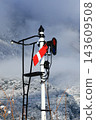 A rare semaphore signal standing in the snow, and a railway landscape of snow-covered mountains. 143609508
