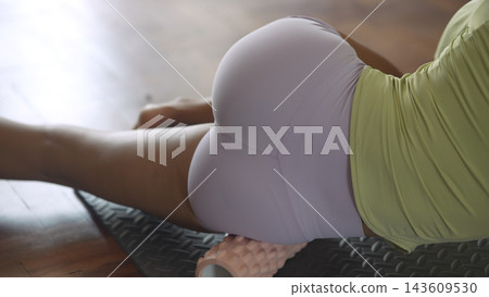 Cropped Side View Of Woman Stretching On Mat Cropped Side View Of Woman Stretching On Mat 143609530