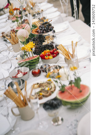 Flowers And Food Fill Garden Reception Table Flowers And Food Fill Garden Reception Table 143609752