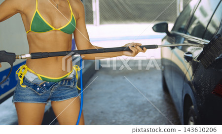 Woman washing a car with pressure washer outdoors Woman washing a car with pressure washer outdoors 143610206