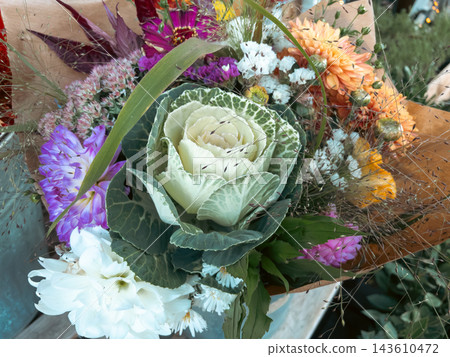 Autumn flower bouquet with ornamental brassica cabbage in craft paper wrap Autumn flower bouquet with ornamental brassica cabbage in craft paper wrap 143610472