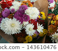 Colorful chrysanthemum flower bouquet wrapped in craft paper at market 143610476