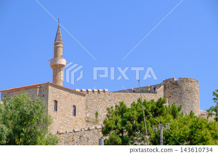 Historic Cesme Castle and Mosque Minaret Against Blue Sky Historic Cesme Castle and Mosque Minaret Against Blue Sky 143610734