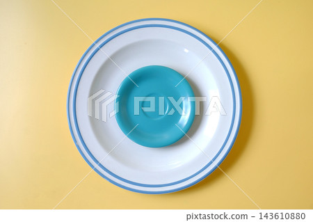 Stack of colorful clean plates on color background. Stack of colorful clean plates on color background. 143610880