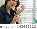 Asian businesswoman working on digital tablet with stylus outside modern building 143611128