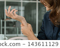 Asian businesswoman working on digital tablet with stylus outside modern building 143611129