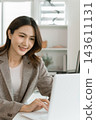 Asian businesswoman working on digital tablet with stylus outside modern building 143611131
