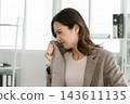 Asian businesswoman working on digital tablet with stylus outside modern building 143611135