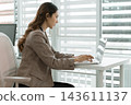 Asian businesswoman working on digital tablet with stylus outside modern building 143611137