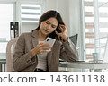 Asian businesswoman working on digital tablet with stylus outside modern building 143611138