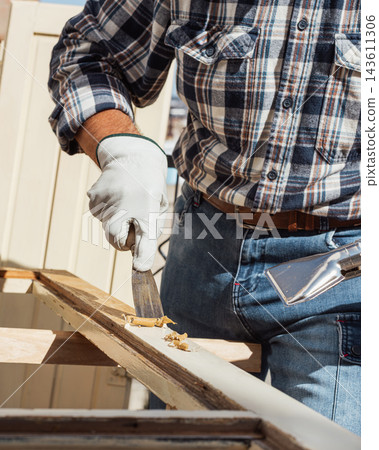 Carpenter at work, restoring an old wooden window. Carpentry. Carpenter at work, restoring an old wooden window. Carpentry. 143611306