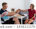 Smart Little Girl Playing Chess With Father During A Lesson On Learning Chess Pieces 143611370
