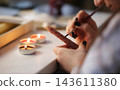 Young Girl Painting A Decorative Candle With Melted Wax And Brush As Hobby For Calm And Relaxation 143611380