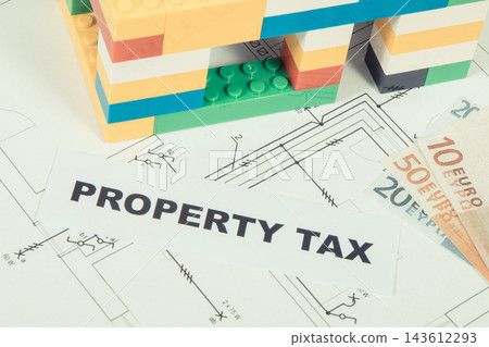 Inscription property tax, house made of colorful blocks, electrical installation plan and euro Inscription property tax, house made of colorful blocks, electrical installation plan and euro 143612293