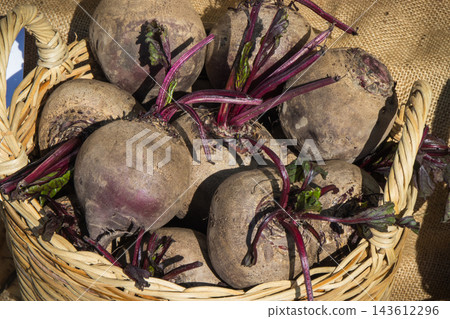 Vegetables in wicker basket on stand at bazaar. Food containing minerals and vitamins Vegetables in wicker basket on stand at bazaar. Food containing minerals and vitamins 143612296