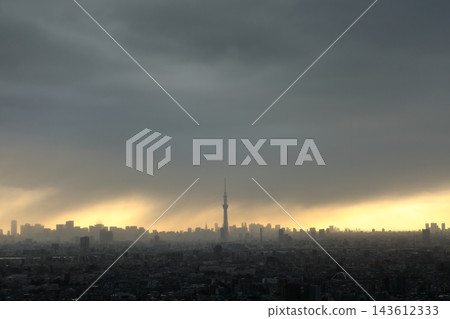 秋季天氣不穩定;雨幕(雨柱)和天使之梯(暮光/光線)在落日餘暉中蔓延;東京城市景觀。 秋季天氣不穩定;雨幕(雨柱)和天使之梯(暮光/光線)在落日餘暉中蔓延;東京城市景觀。 143612333