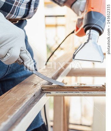 Carpenter at work, restoring an old wooden window. Carpentry. Carpenter at work, restoring an old wooden window. Carpentry. 143612335