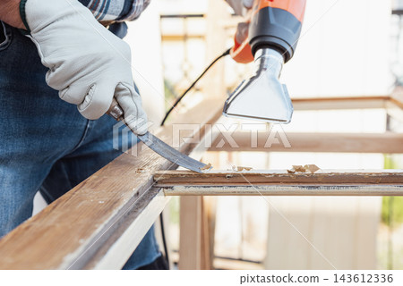 Carpenter at work, restoring an old wooden window. Carpentry. Carpenter at work, restoring an old wooden window. Carpentry. 143612336