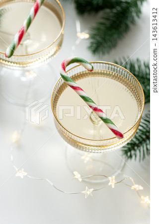 Top view of champagne glasses decorated with candy canes for winter holidays Top view of champagne glasses decorated with candy canes for winter holidays 143613412