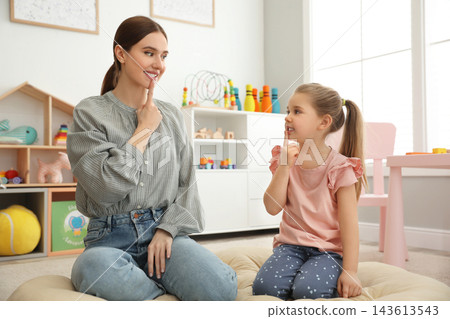 Speech therapist working with little girl in office Speech therapist working with little girl in office 143613543