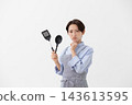 The image of a woman struggling in the kitchen 143613595
