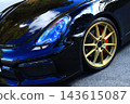 A glossy black sports car 143615087