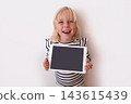 Happy Little Blonde Girl Holding Digital Tablet with Blank Screen  143615439