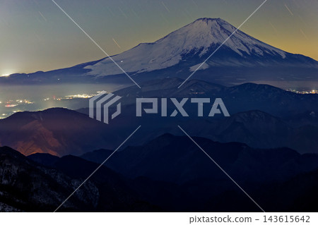 Mount Fuji at night as seen from the summit of Mt. Tōnodake in the Tanzawa Mountains. Mount Fuji at night as seen from the summit of Mt. Tōnodake in the Tanzawa Mountains. 143615642