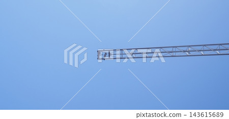 Long Crane Boom Extending Across Blue Sky 143615689