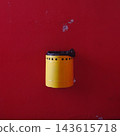 Yellow Trash Bin on Red Wall 143615718