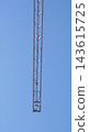 Vertical Tower Crane Mast Against Blue Sky 143615725