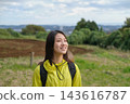 Portrait of a smiling woman hiking in the Shibusawa Hills 143616787
