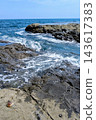 White waves crashing against the rocky shores of Japan and the blue sea 143617383