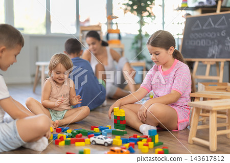 Boy and girl playing on floor with educational toys. Children toddlers at daycare 143617812