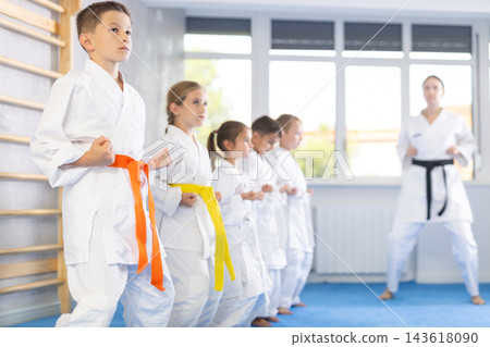Kids during karate training. Martial arts. Active lifestyle concept Kids during karate training. Martial arts. Active lifestyle concept 143618090