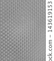 Close-up shot of a gray woven plastic texture, showcasing a geometric basketweave pattern with horizontal and vertical strips. Ideal for modern backgrounds, abstract designs, or textile concepts. 143619153