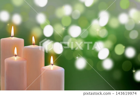 Lit candles with festive holiday green bokeh lights in background Lit candles with festive holiday green bokeh lights in background 143619974