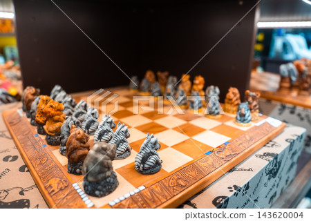 Handcrafted wooden chess set with sculpted African wildlife pieces rests inside a souvenir shop shelf at Cape Town International Airport, South Africa. Handcrafted wooden chess set with sculpted African wildlife pieces rests inside a souvenir shop shelf at Cape Town International Airport, South Africa. 143620004
