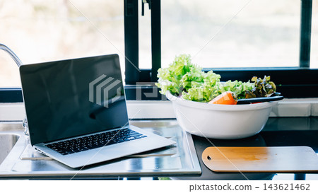 A mockup black screen laptop placed on a vegetable background A mockup black screen laptop placed on a vegetable background 143621462