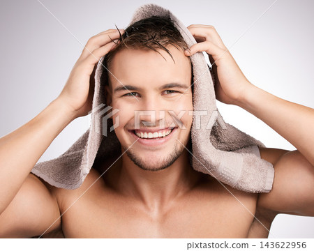Studio, towel and man in portrait for haircare, collagen and cosmetic after shower with confidence. White background, male model and fabric for freshness, hygiene and healthy routine as treatment Studio, towel and man in portrait for haircare, collagen and cosmetic after shower with confidence. White background, male model and fabric for freshness, hygiene and healthy routine as treatment 143622956